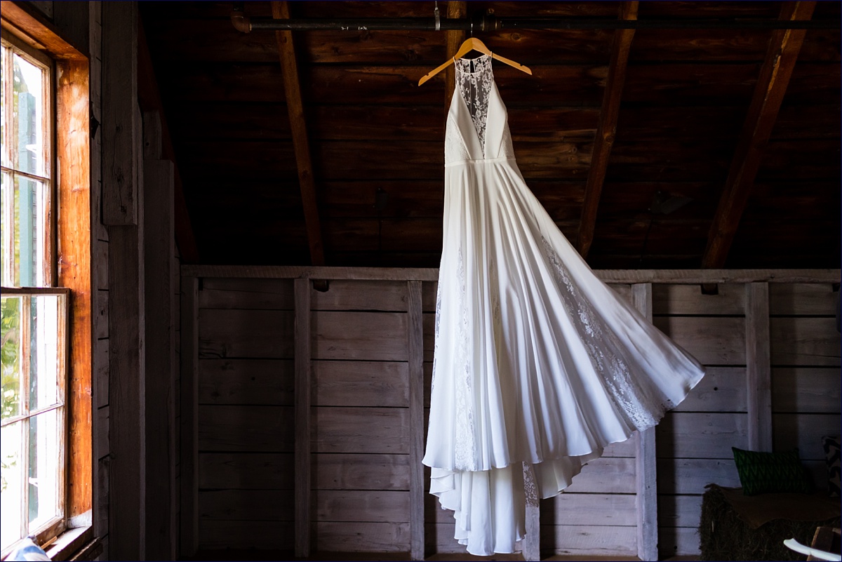 Wedding gown blowing in the wind in the old hay loft