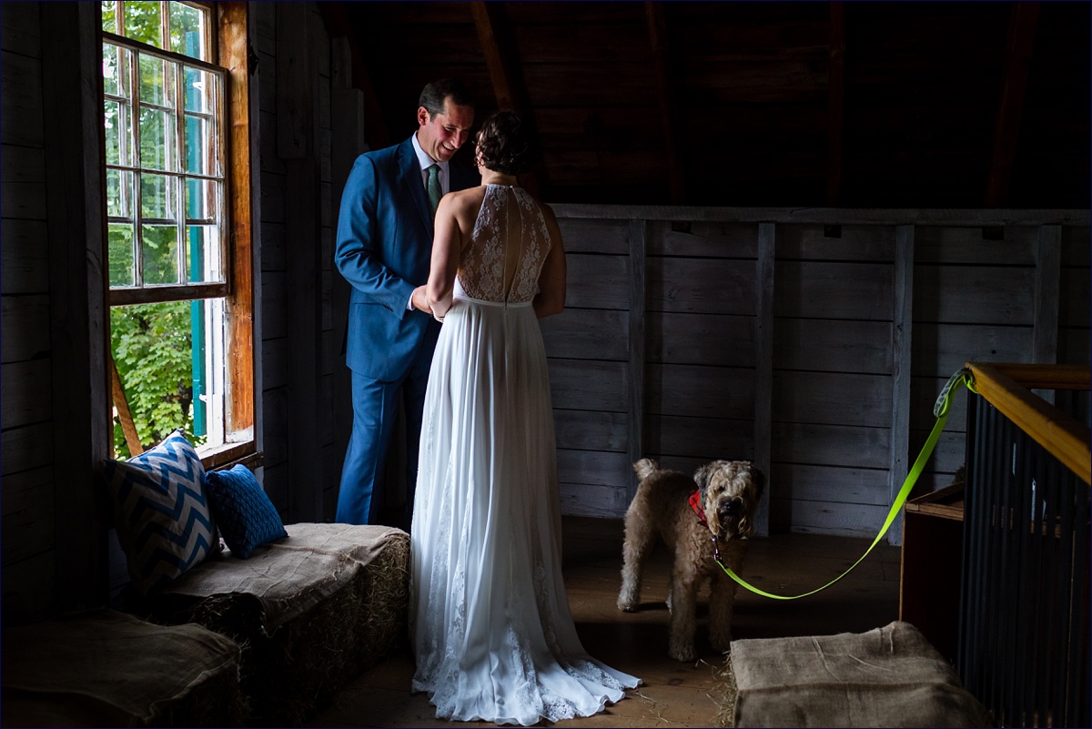 Maine Hardy Barn bride and groom enjoy their first look in the hay loft