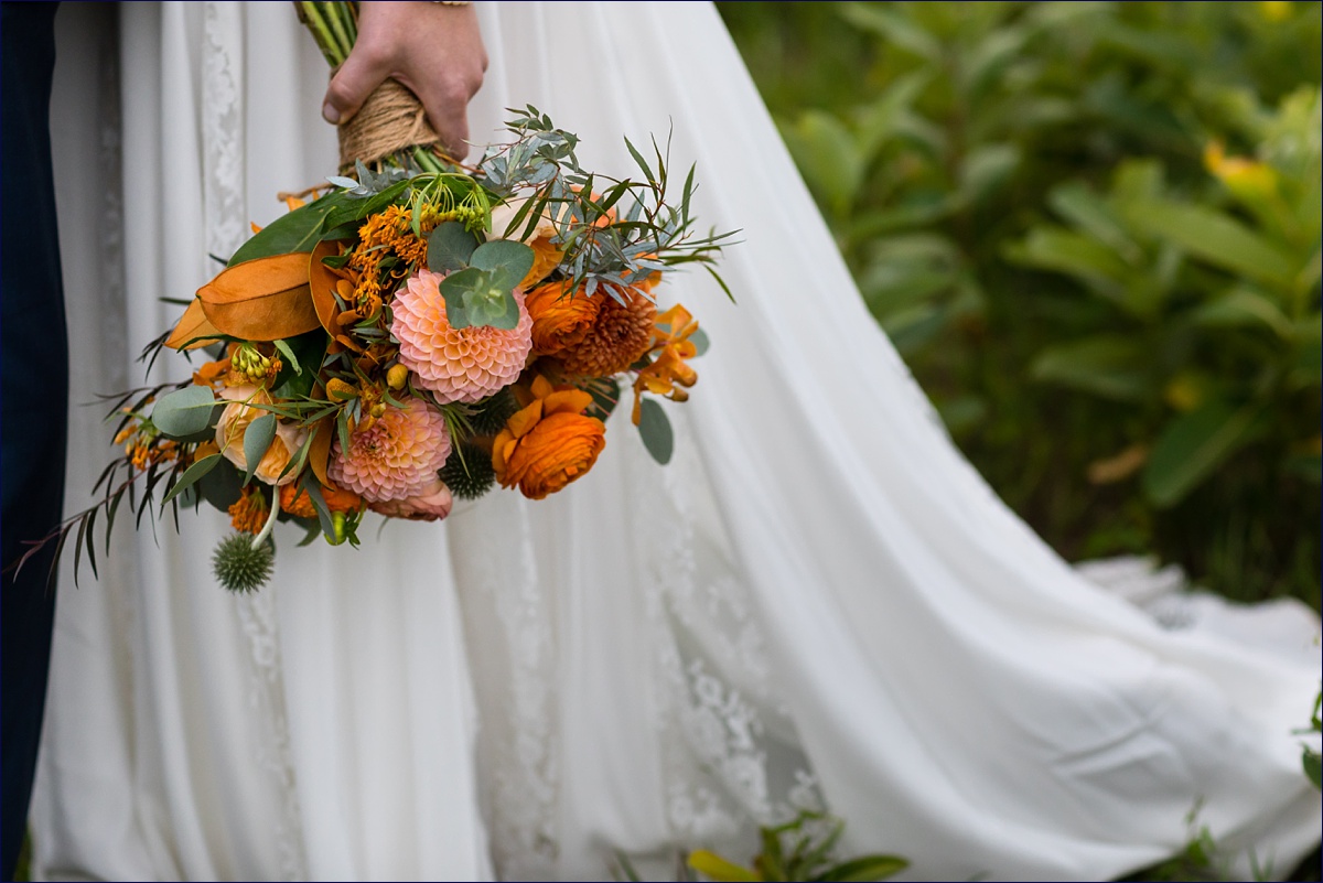 Maine bride and her fall bouquet out in the wild 