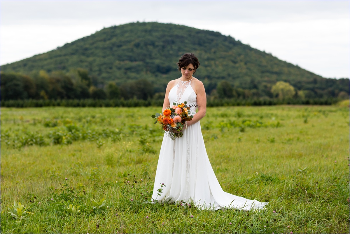 Bride with her fall bouquet in front of the white mountains Maine