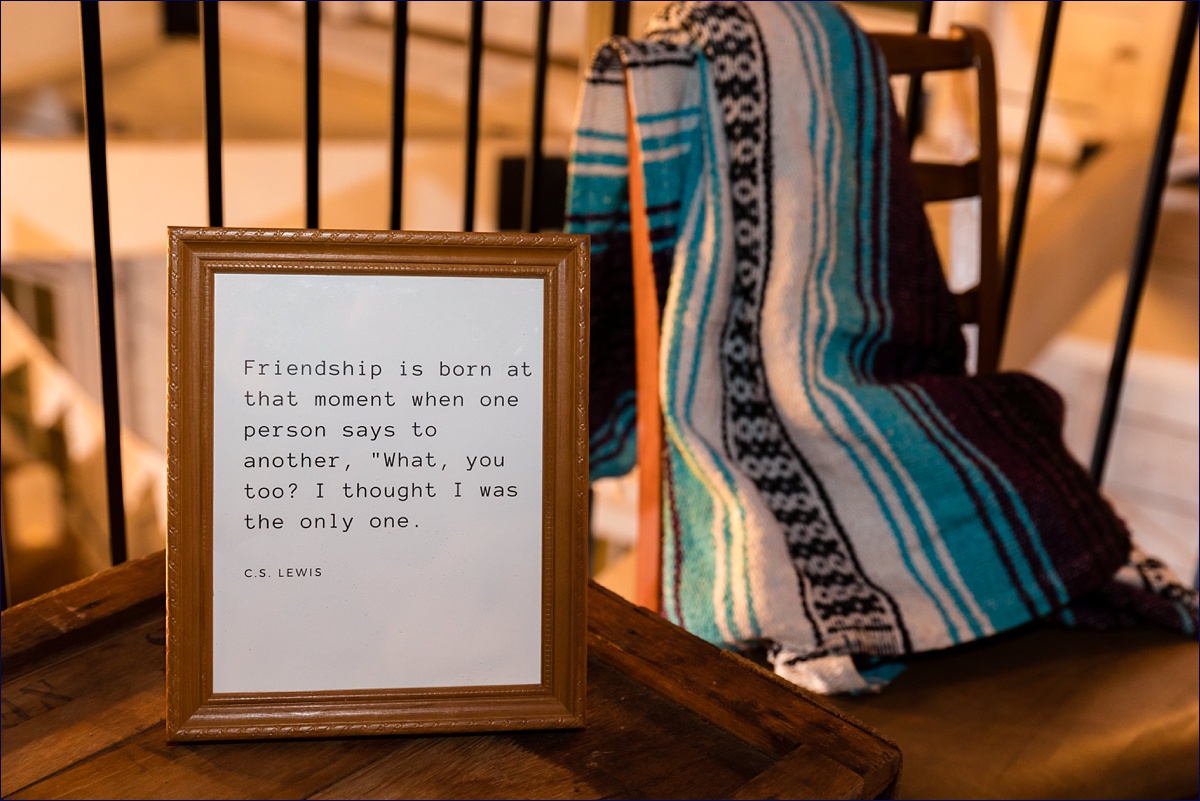 Literature quotes decorate the wedding reception along with hygge inspired elements of blankets