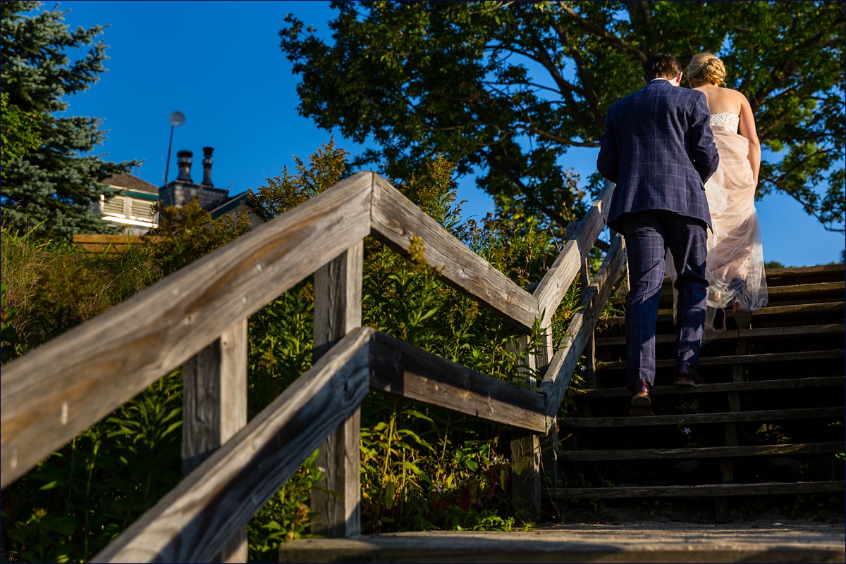 Maine Peaks Island bride and groom heading up the wooden stairs