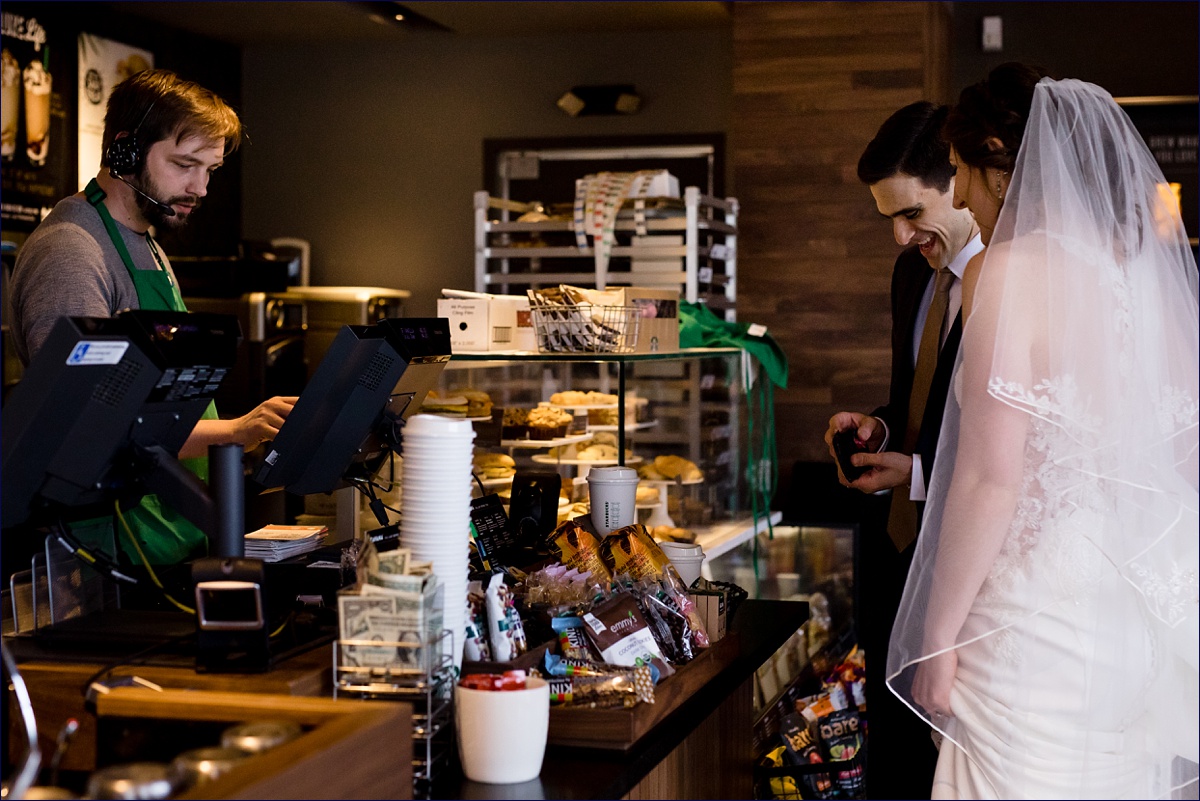 The bride and groom buy a coffee at Starbucks after their intimate wedding celebration