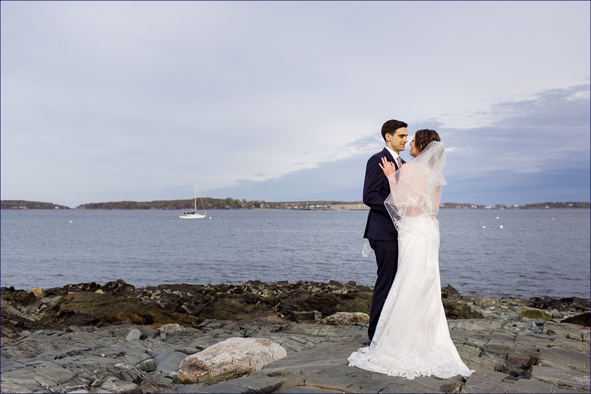 Portland Maine Wedding Photographer the bride and groom take in the ocean air along the Eastern Promenade