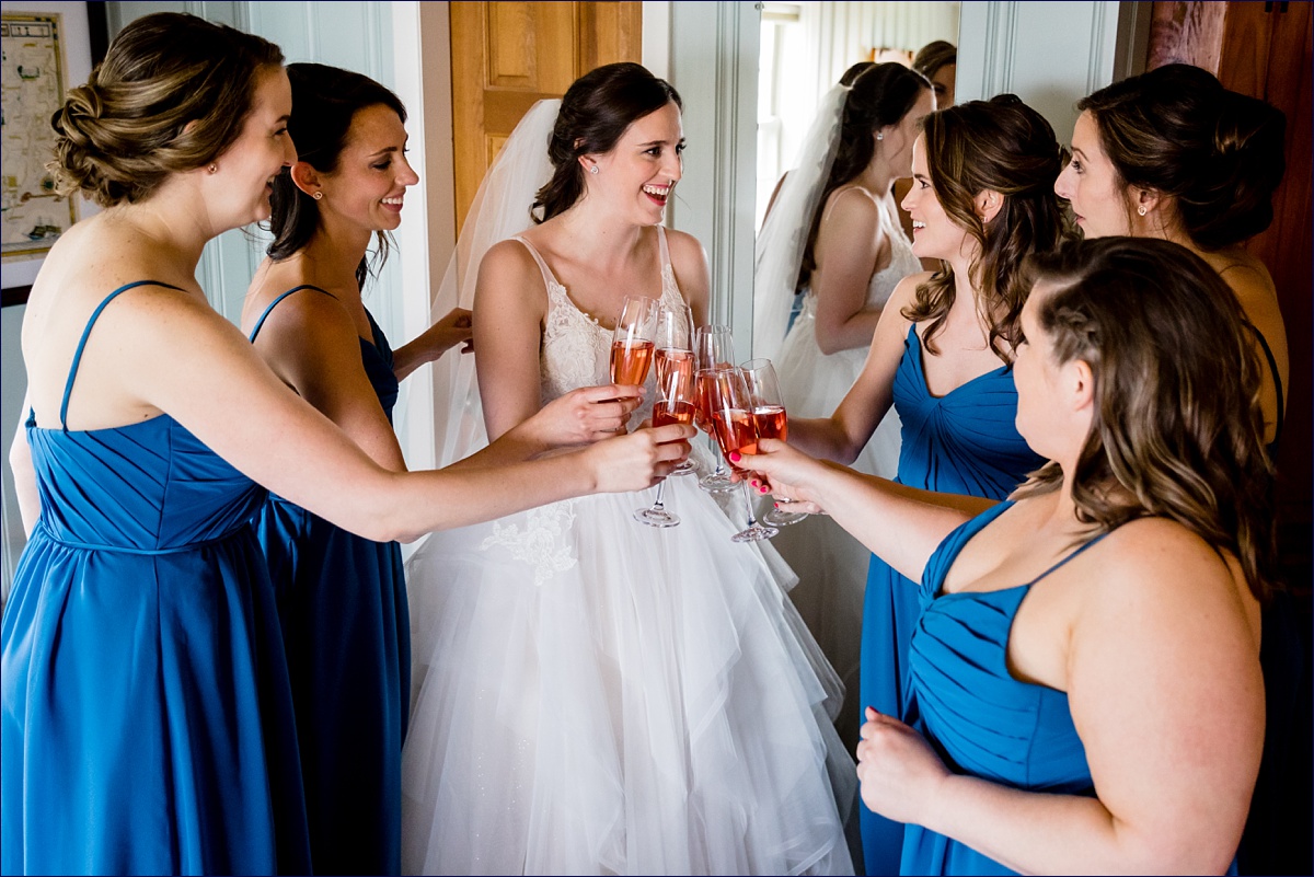 The bride and her bridesmaids toast to the day on the morning of her wedding
