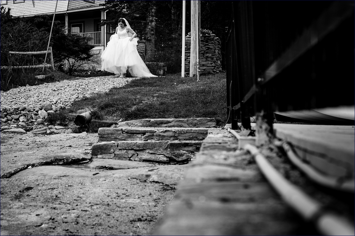 The brides heads down to the water in Boothbay Harbor Maine for a first look with her groom