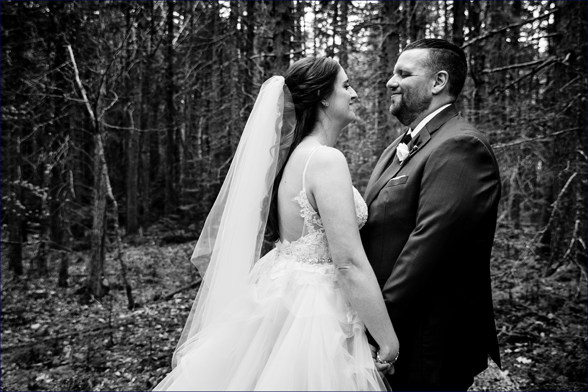 The bride and groom get in close in the woods of Spruce Point Inn after the wedding ceremony