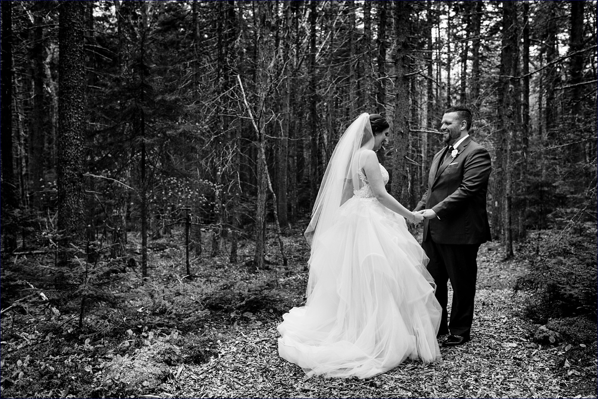 The wife and husband dance with each other in the lush green woods at their Boothbay Maine wedding