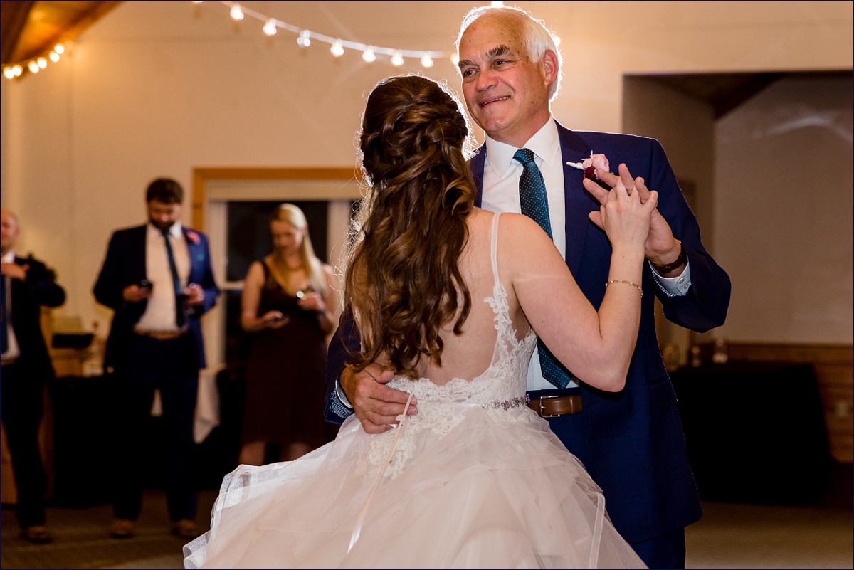 The bride and her father have a dance at the wedding reception