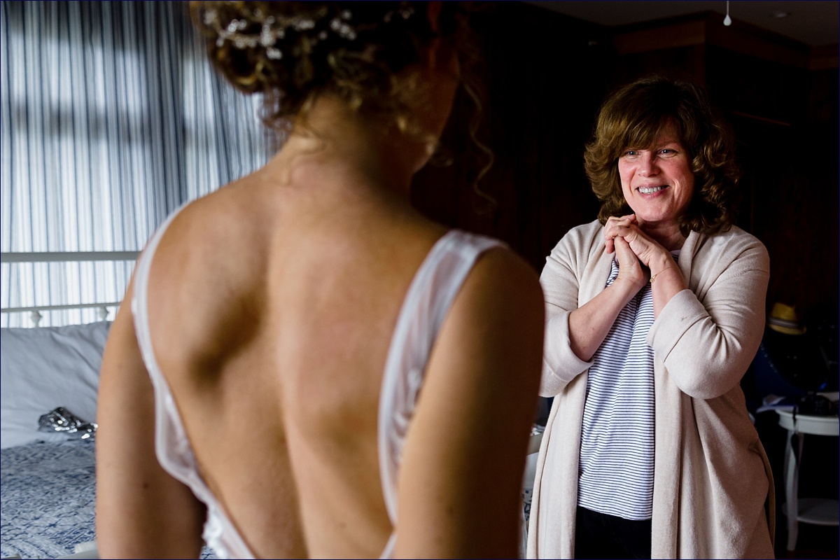 Linekin Bay Resort Wedding Photographer in Boothbay Maine the bride's mother reacts to seeing the wedding dress