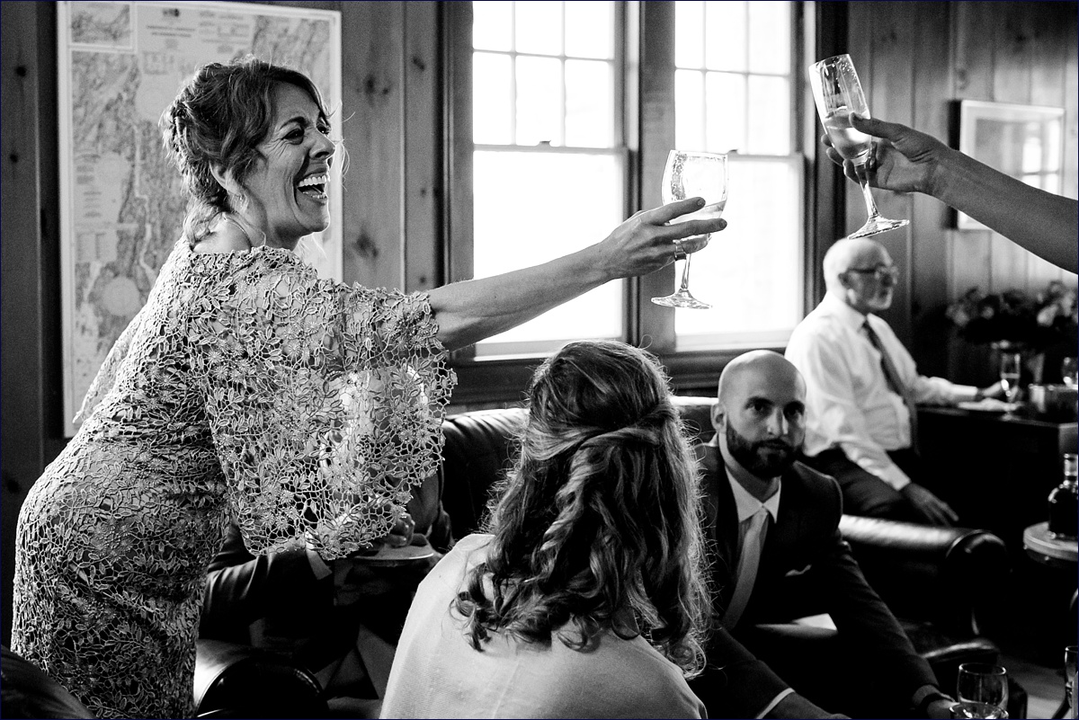 Linekin Bay Resort Wedding Photographer in Boothbay Maine the mother of the bride toasts to the soon to be wed 