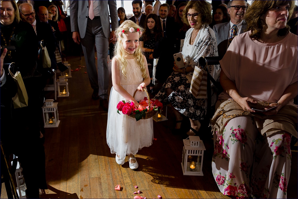 Linekin Bay Resort Wedding Photographer in Boothbay Maine the flower girl comes down the aisle during the ceremony