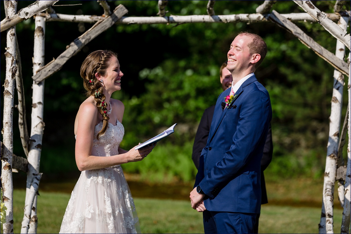 The bride and groom read their vows to one another during the outdoor NH wedding ceremony