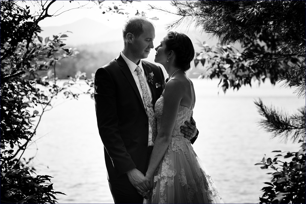The bride and groom get in close in front of Lake Chocorua on their wedding day