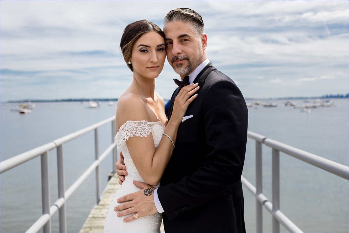 Greek Orthodox Massachusetts Wedding Photographer the bride and groom look gorgeous together out on the docks with Boston in the background