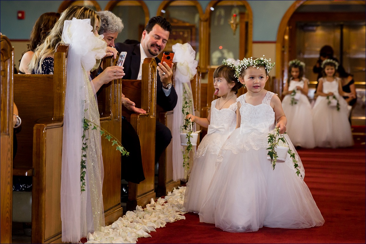 St George Greek Orthodox Massachusetts Wedding Photographer the flower girls head down the aisle during the ceremony