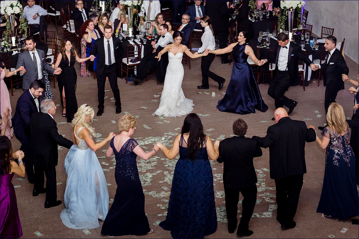 The bride, her Koumbara and family dance the Kalamatiano on her wedding day as part of the Greek tradition and custom
