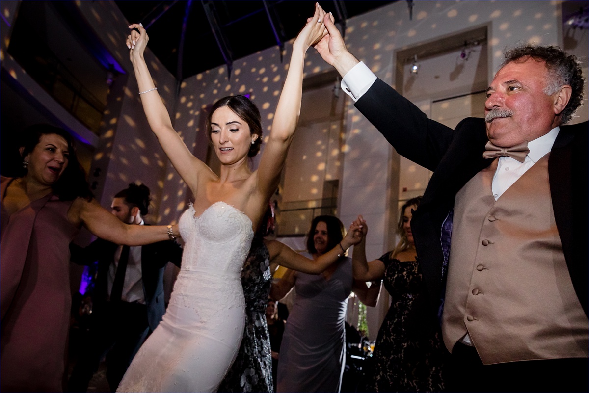 The bride and her dad dance the Kalamatiano on her wedding day as part of the Greek tradition and custom