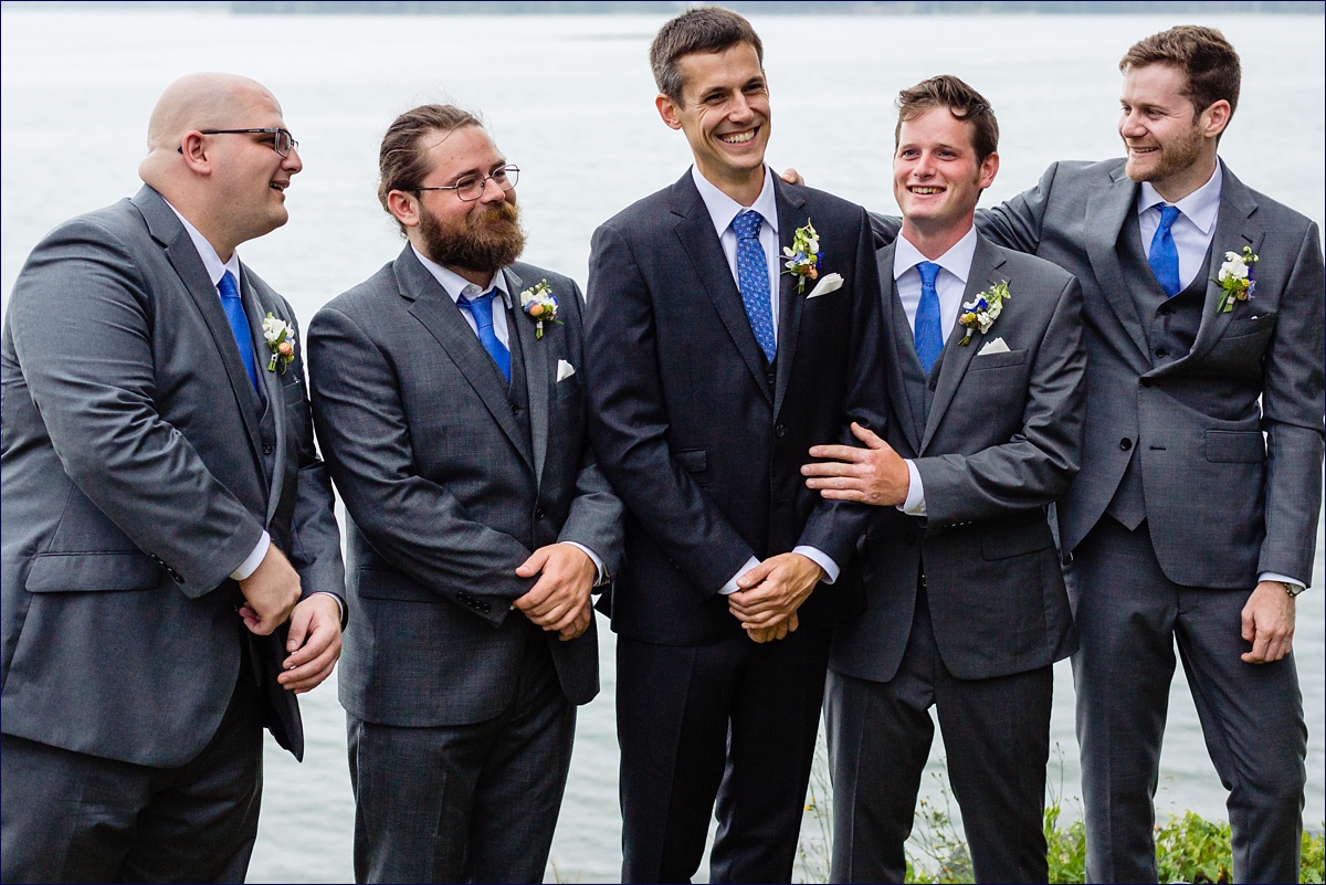 The groom and his groomsmen enjoy some time together before the waterfront ceremony