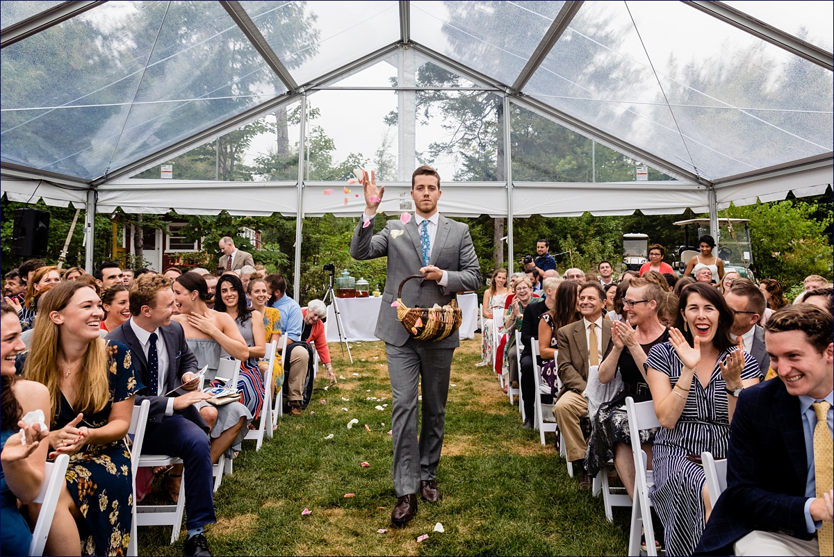 Acadia Bar Harbor wedding with the flower man throwing petals for the bride's grand entrance