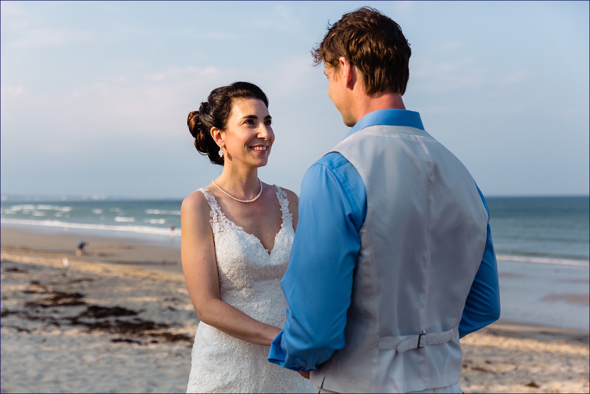 The groom during their intimate ceremony on the Maine beach in summer