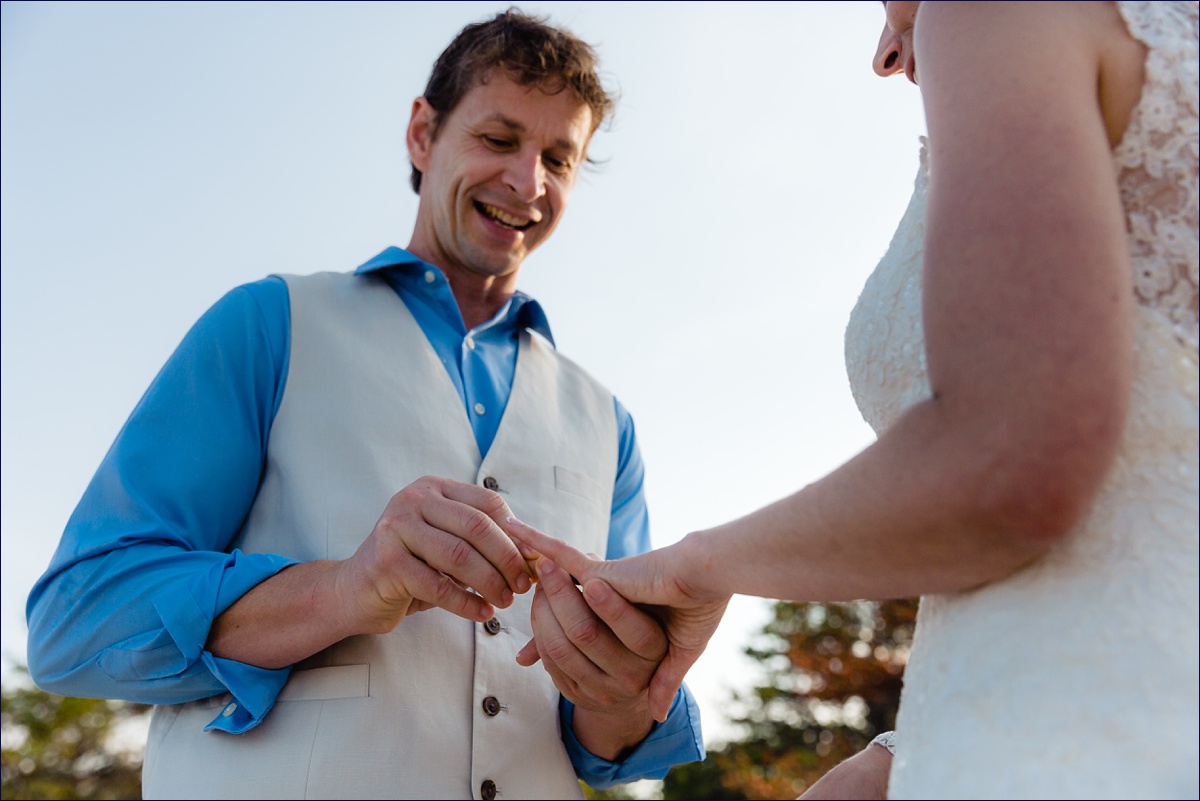The groom seals the ceremony with a ring on the bride's finger during their intimate ceremony