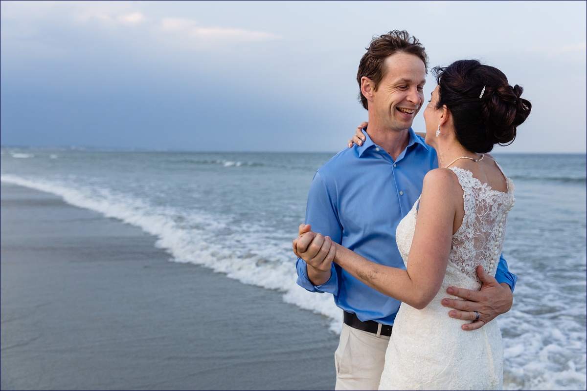 The newlyweds dance in the waves in Maine for their elopement