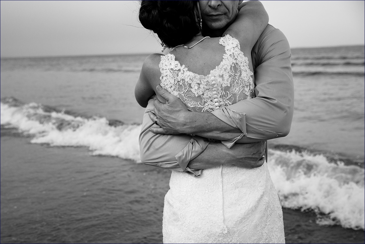 Saco Beach Maine Elopement the newlyweds hug each other close after their intimate ceremony