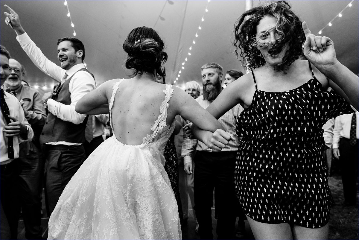 The guests dance at the outdoor Maine wedding reception