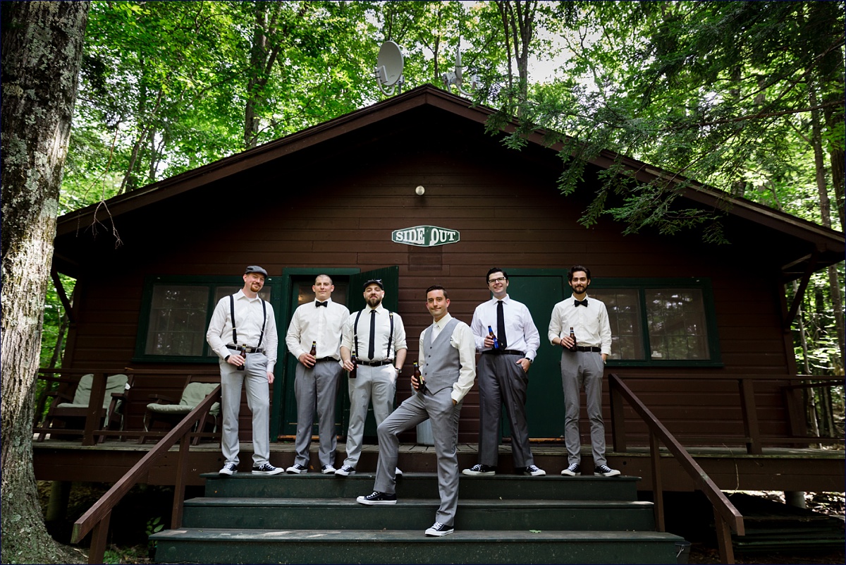 Camp Wedding Day the groom and groomsmen on the stairs of a cabin in New Hampshire while they wait for the wedding to get underway