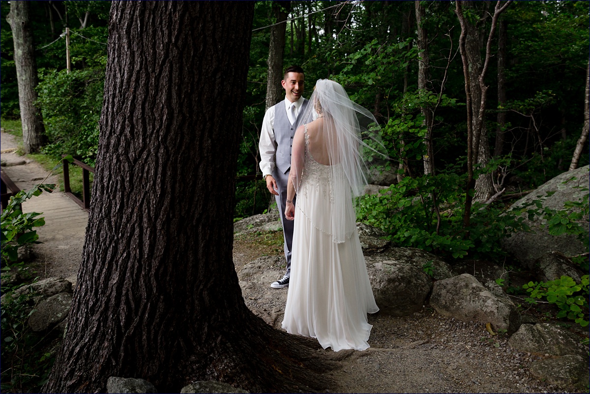 The look of the groom's love for his bride at their wooded first look at Camp Wa Klo in NH