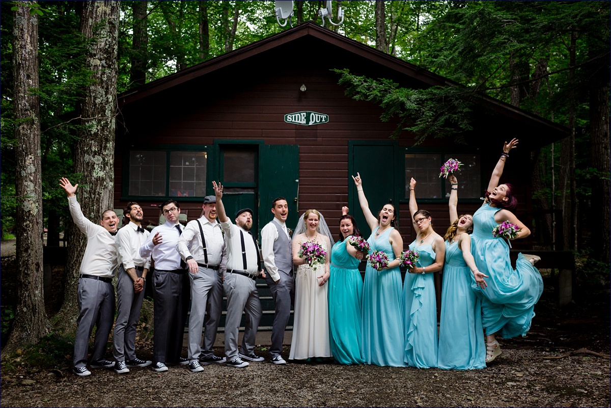 The entire wedding party celebrates with the newlyweds at their New Hampshire camp wedding