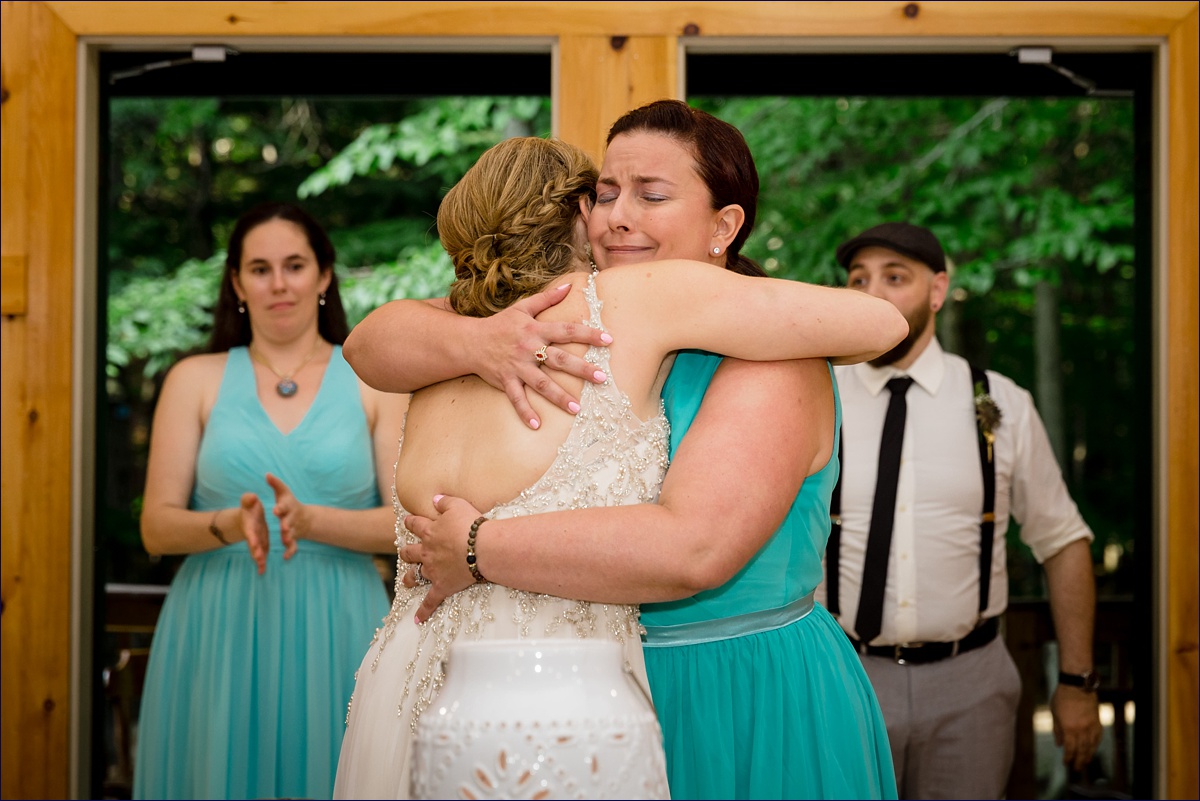 The maid of honor hugs the bride tight after her toast