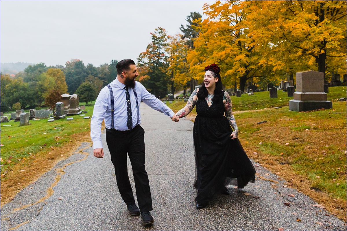 NH elopement hosts the bride and groom as they walk in Pine Hill Cemetery in Dover after eloping
