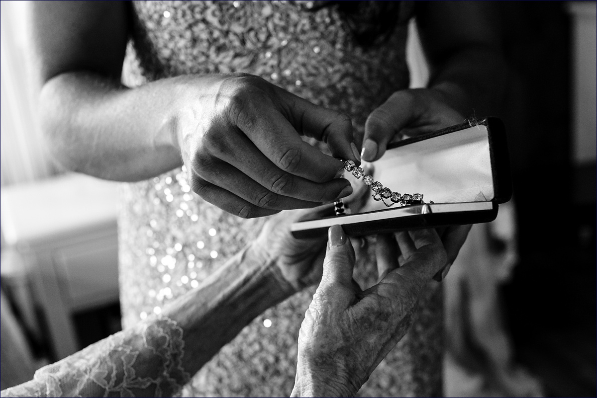 The bride's grandmother gives her a family heirloom as a gift for the bride on her wedding day