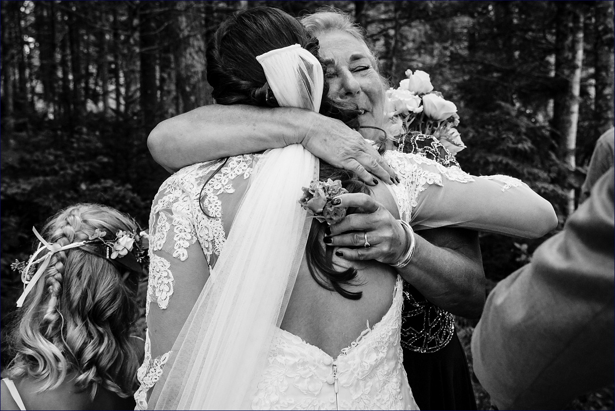 The bride hugs her mother in law after the wedding ceremony