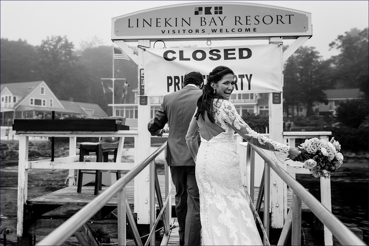 The bride is all smiles as she runs into her wedding reception at Linekin Bay Resort in Boothbay Maine