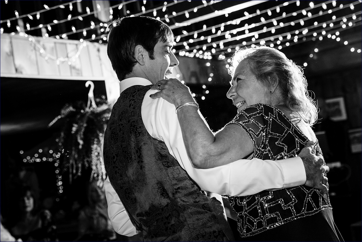 The groom and his mom dance at the camp style reception