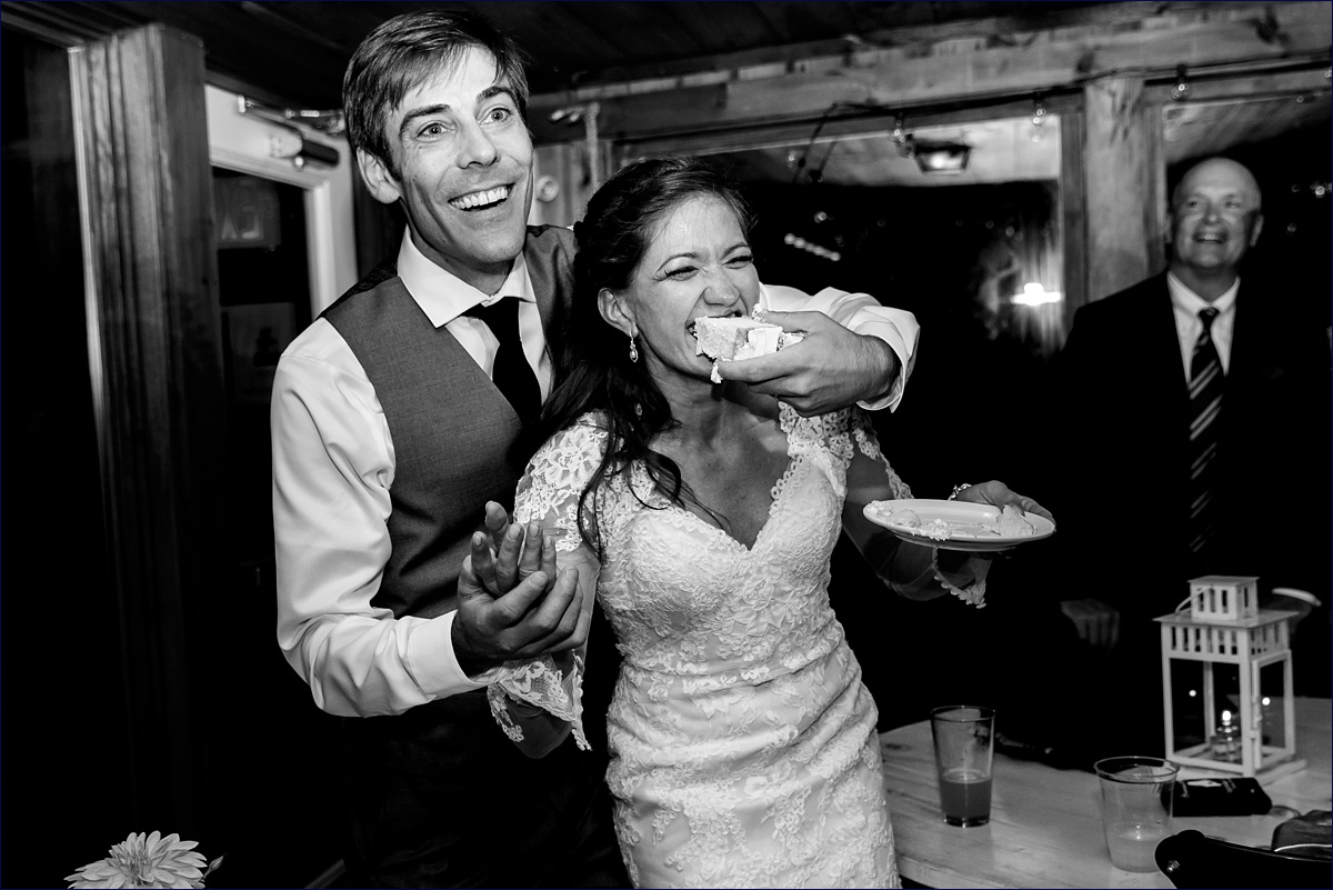 Linekin Bay Resort wedding in Boothbay Harbor Maine with the bride and groom playfully feeding each other wedding cake