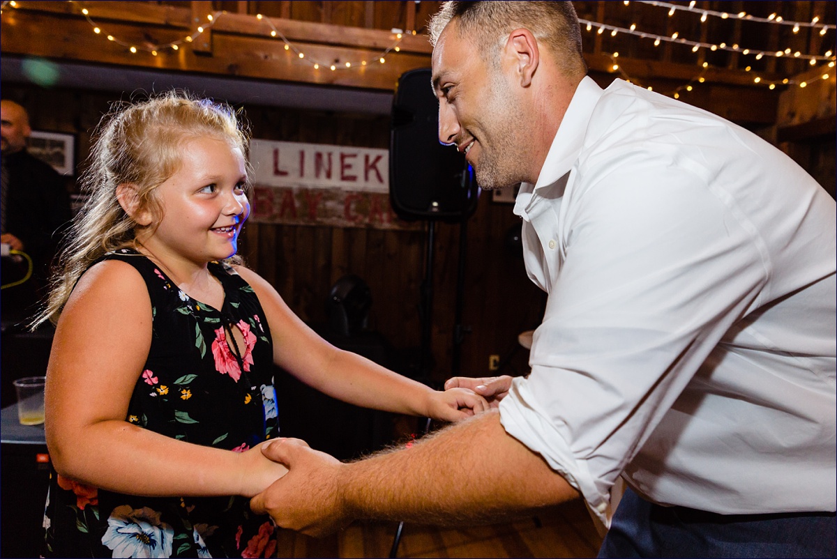 The best man and the flower girl dance at the wedding reception
