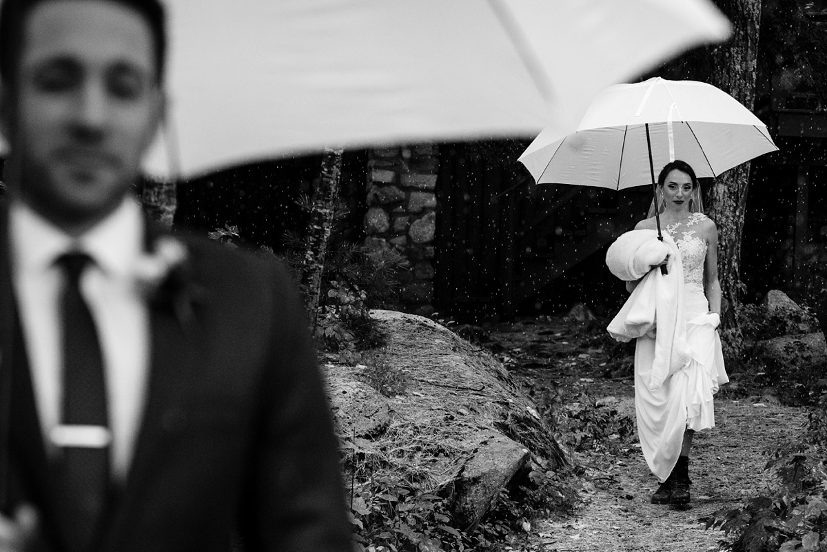 The bride heads to the groom during their first look in the snow at Migis Lodge in Maine