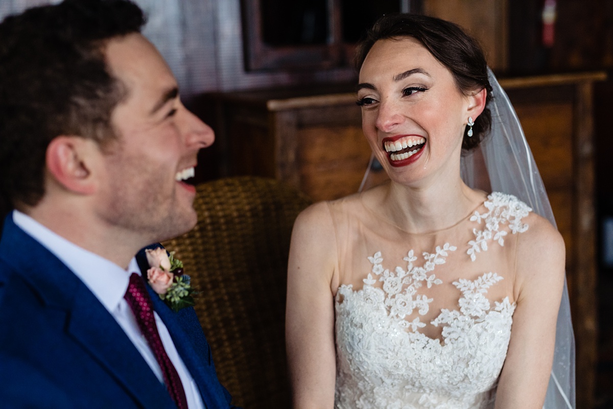 The soon to be wed couple laughs together in a cabin