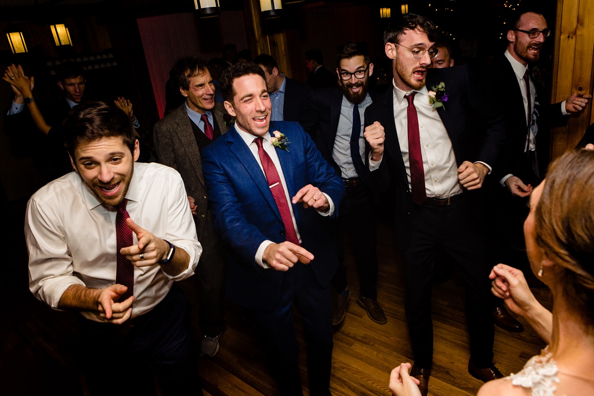The groom gets into the party at his Maine wedding reception