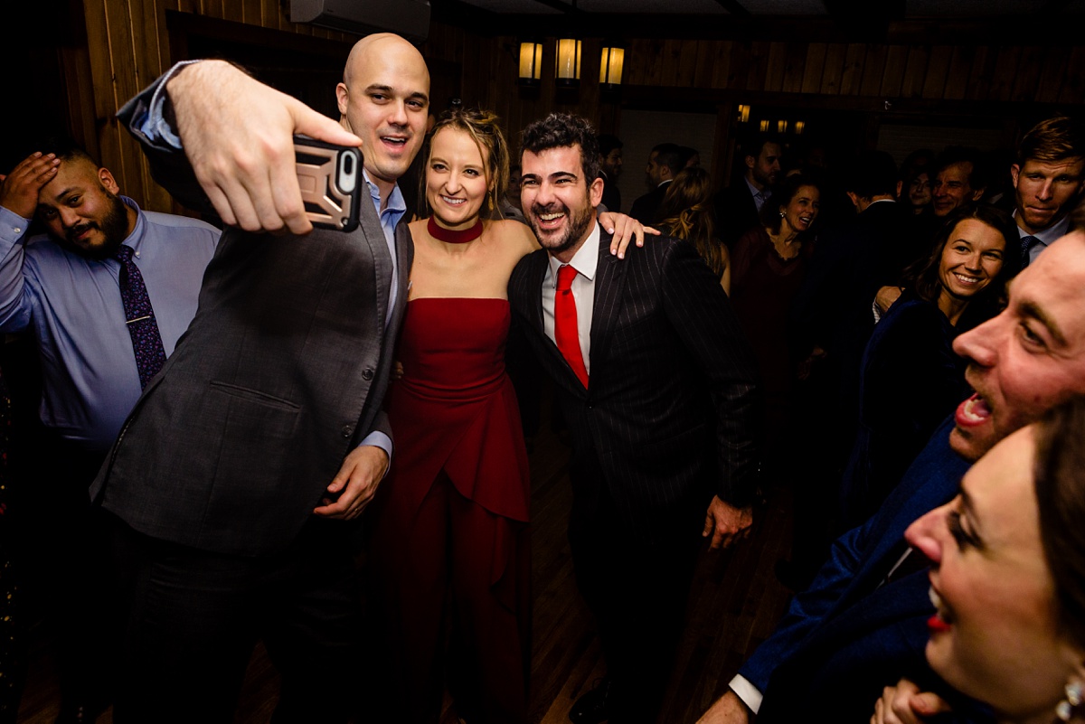 Guests at the wedding do a quick dance floor selfie