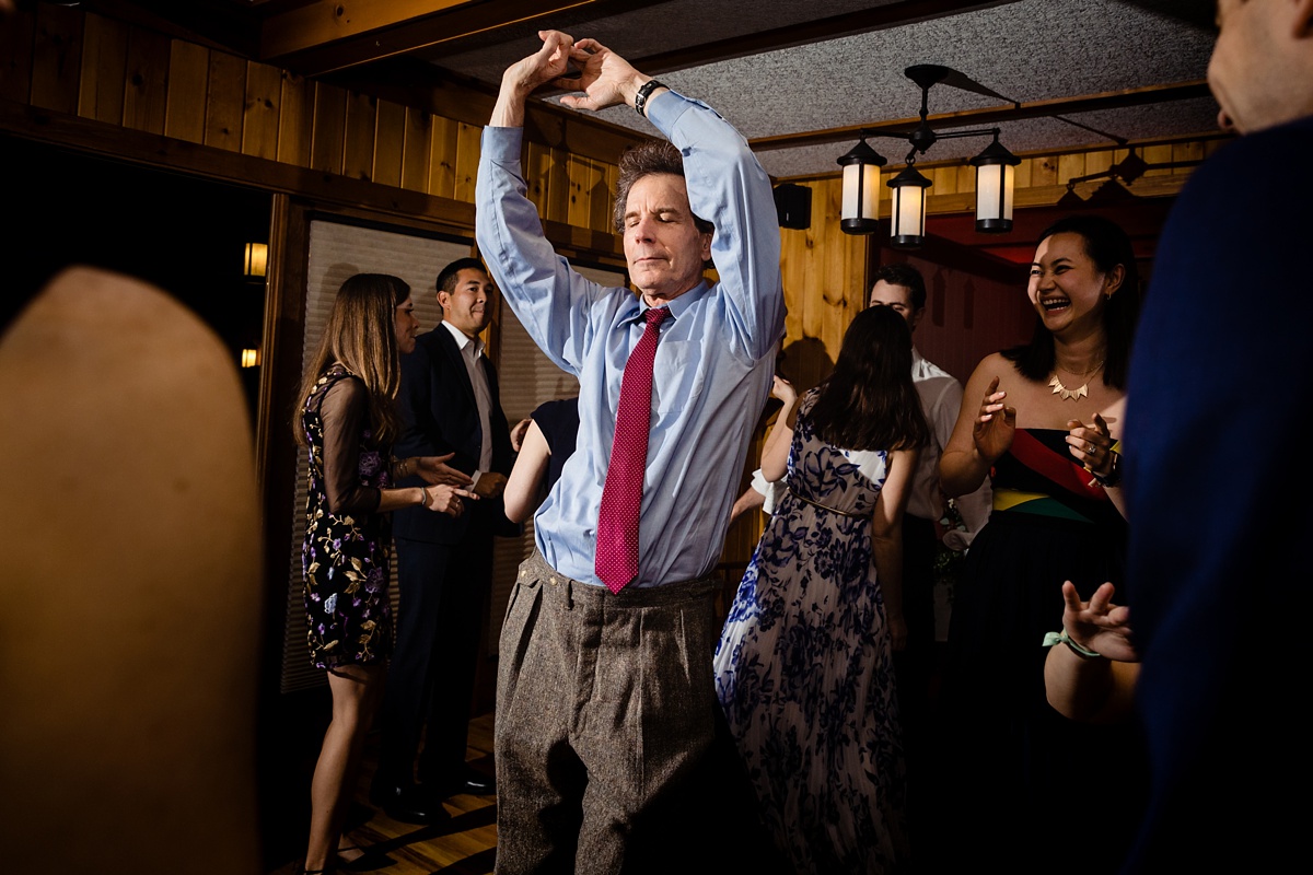 The father of the bride dances at his son's wedding reception