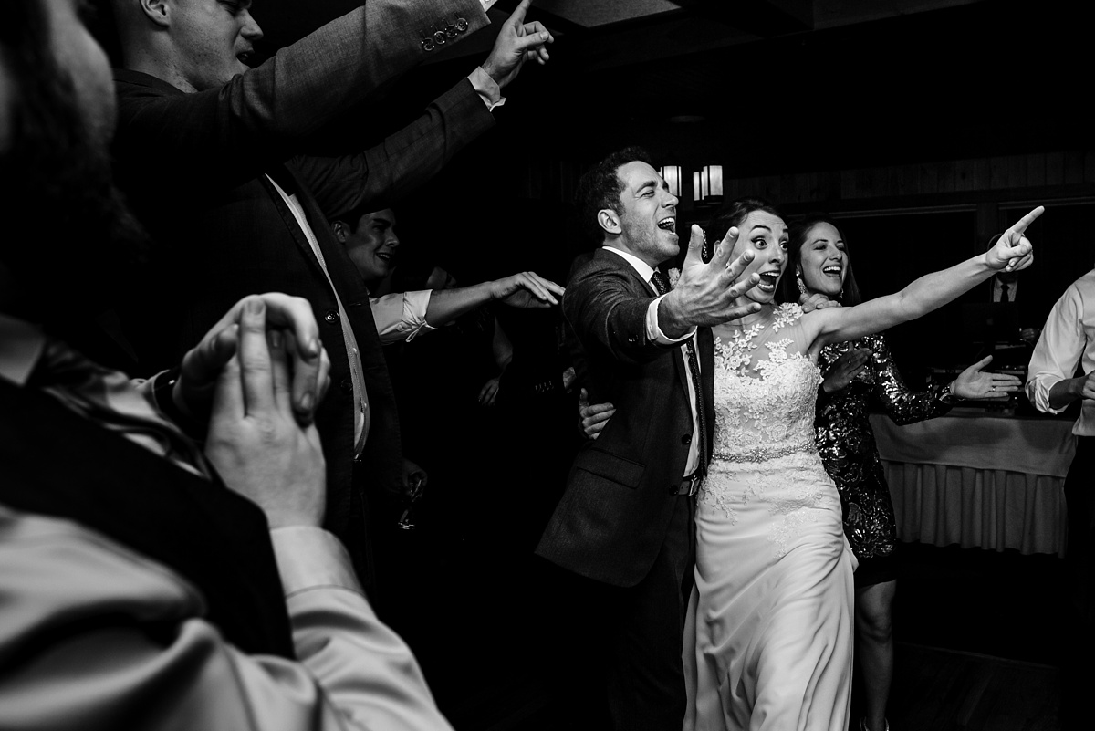 The bride and groom get into the dancing at their Migis Lodge wedding reception