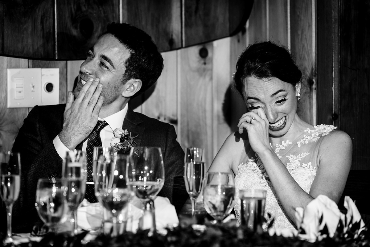 The bride and groom tear up at the toasts during their Migis Lodge Wedding reception