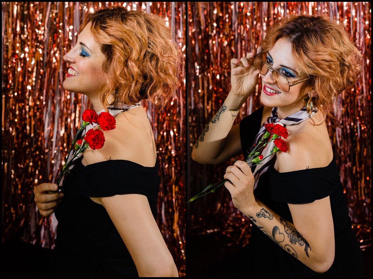Natalee Miller stuns in black and red in front of a rose gold tinsel wall for her portraits