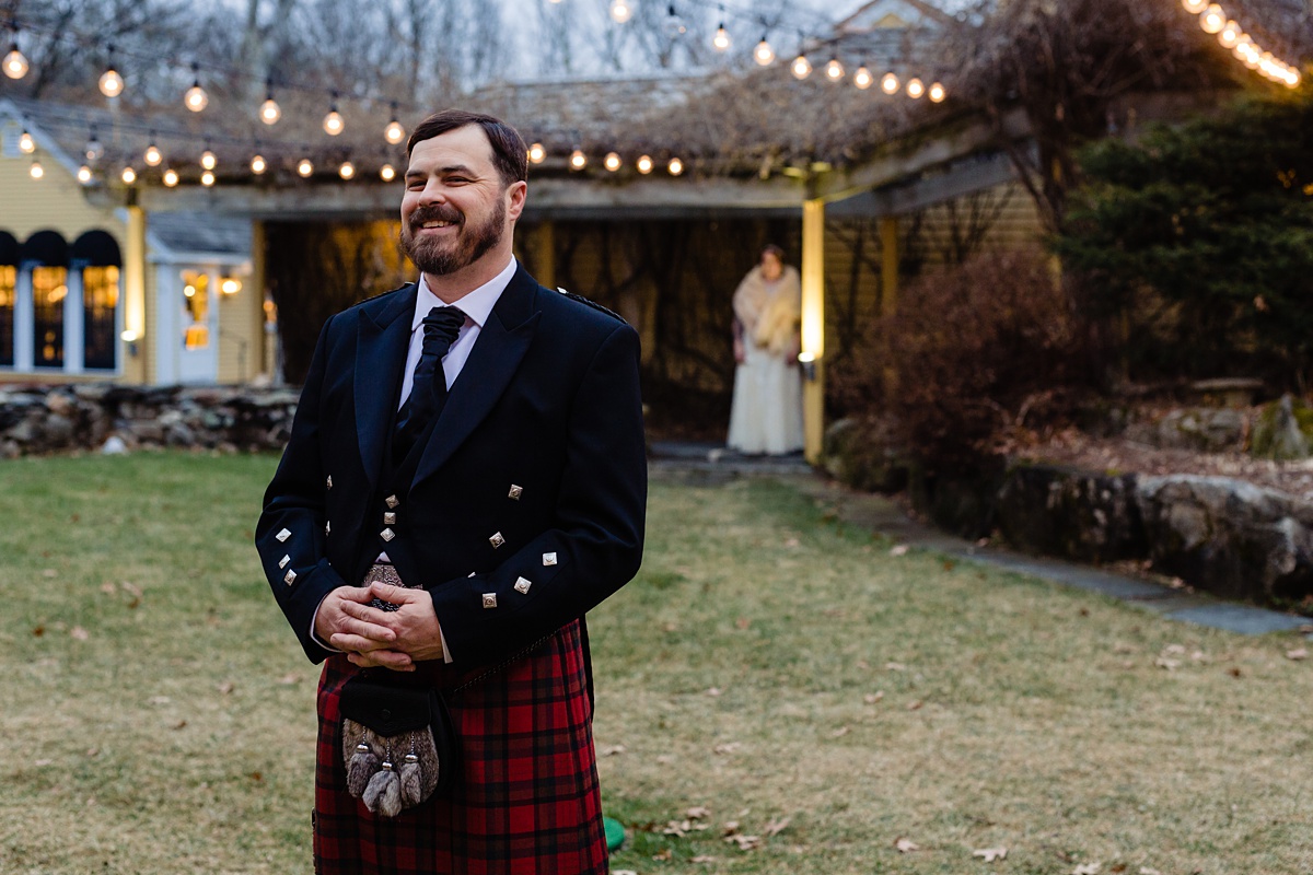 The groom stands in his kilt waiting for the bride to arrive for their first look with one another