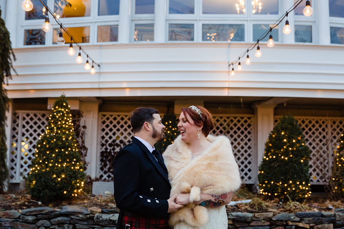 Bedford Village Inn New Hampshire elopement the bride and groom hold each other at their December intimate wedding under the bistro lights